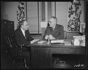 Two men sitting at a desk