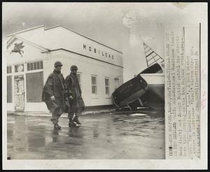 National Guard Out as New England Waits Edna-National Guardsmen Dennis Beck (left) and Joseph Baptist patrol the streets here this morning as the New England coast prepares for hurricane 'Edna'. A boat washed ashore in hurricane 'Carol' eleven days ago, is at right.