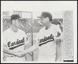 New Cardinal Combination Blasts Giants-- Don Blasingame (left) rookie second baseman of the St. Louis Cardinals, and shortstop Alvin Dark, veteran star obtained from the New York Giants in a recent trade, shake hands before today’s game in which they blistered the Giants for five more hits, leading the Redbirds to a three-game series sweep. Dark batted .818 and drove in seven runs in the series. Blasingame hit .727 and scored eight times.