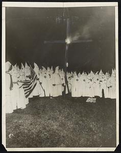 Louisiana Klan Active as Governor Interests Government in Fight: While Governor John Parker of Louisiana was in Washington in endeavor to interest Government in his fight to check the spread of the Ku Klux Klan movement in his home State, the Klan was as active as ever, as shown in photo above, a scene at first New Orleans, La. institution of the Klan which took place when Gov. Parker was at the Capitol.