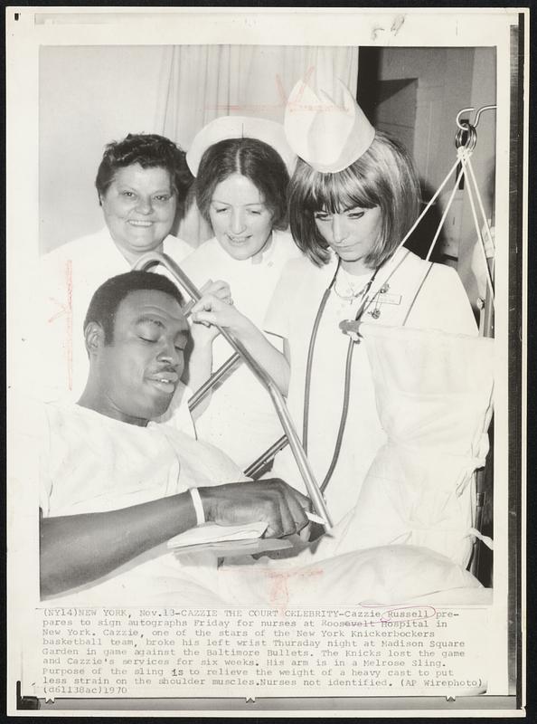 Cazzie The Court Celebrity – Cazzie Russell prepares to sign autographs Friday for nurses at Roosevelt Hospital in New York. Cazzie, one of the stars of the New York Knickerbockers basketball team, broke his left wrist Thursday night at Madison Square Garden in game against the Baltimore Bullets. The Knicks lost the game and Cazzie’s services for six weeks. His arm is in a Melrose Sling. Purpose of the sling is to relieve the weight of a heavy cast to put less strain on the shoulder muscles. Nurses not identified.