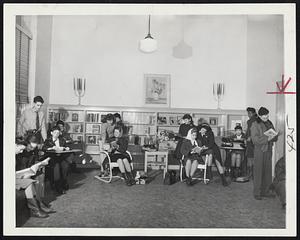 Making Themselves at Home in their new teen-age lounge in St. Agnes Branch of the New York Public Library, the youngsters from the neighborhood, which has about 12,000 teen-agers, not only read, but play checkers and chess, chat, plan dramatic activities and listen to the radio. A sound-proof wall separates the lounge from the adult reading room.