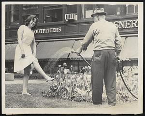 City Hall flowers watered- Nancy Thompson of Dorchester cools her feet under hose spray, Jos. Tuiliani, Park Dept. employee, watering City Hall tulips