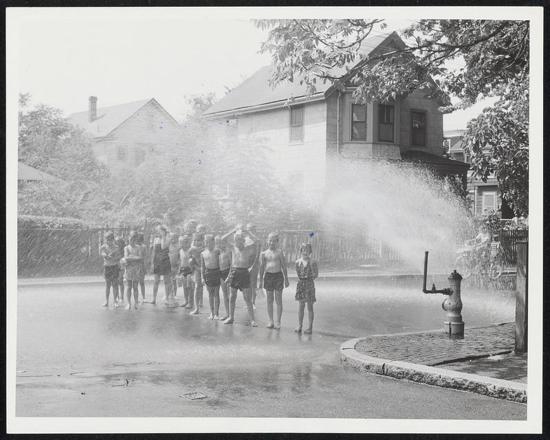 At Sherman St.- Cambridge where firemen fired a hydrant to keep kids cool.