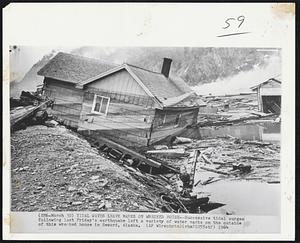 Tidal Waves Leave Marks on Wrecked House -- Successive tidal surges following last Friday's earthquake left a variety of water marks on the outside of this wrecked house in Seward, Alaska.