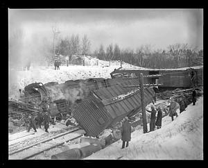 People looking at damage of a train accident