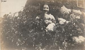 Woman in flowering shrub