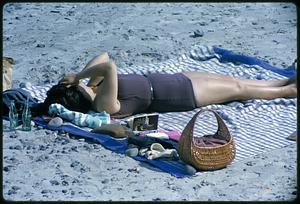 Woman sunbathing on sand