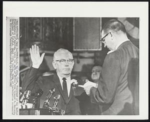 Sworn--I. W. Abel, left, President of the United Steelworkers of America, takes the oath of office from Leonard R. Kennedy, President of U.S.W.A. Local 1123, Canton, Ohio, at installation ceremonies in Pittsburgh Tuesday.