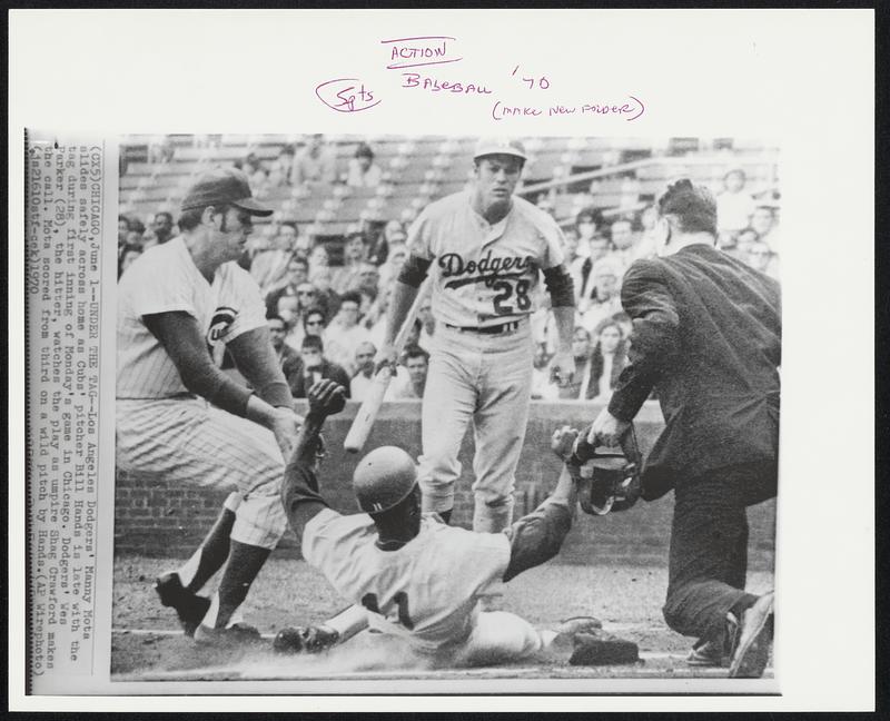 Under the Tag -- Los Angeles Dodgers' Manny Mota slides safely across ...