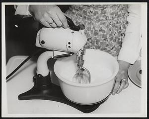 Make Butter at Home. New Bedford, Mass.-- Making butter in her home, Miss Joan Harrington, a vocational High School student here, starts the electric mixer to whip up the heavy cream she has poured into the bowl. The mixing should be continued until the cream begins to solidify.