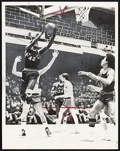On the Rebound-Ron Williams (32) grabs rebound during Boston English's 84-71 victory over South Boston before yesterday's Celtics game at Garden. With Williams is teammate Carlton Smith (15), who scored 27 points.