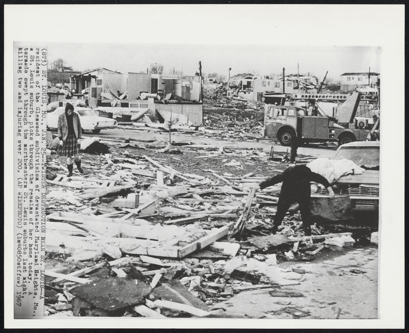 St. Louis, Mo. – Twister Destruction Near St. Louis – A resident of the Glenwood subdivision of devastated Maryland Heights, Mo., a St. Louis suburb, picks through the remains of her home today. A tornado swept through the northwestern St. Louis suburbs last night, killing two and injuring over 200.