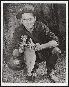 Record Squaretail? – Sidney Baker of West Ossipee, N.H., holds the five-pound, two-ounce sqauretail trout he caught trolling a fly on Ossipee Lake. The 21-inch fish took a half-hour to land and is expected to be a near-record catch for the state this season.