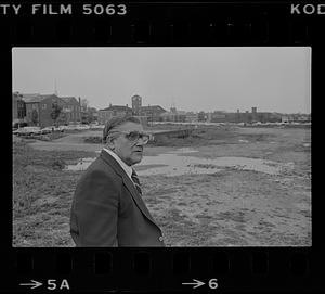 Peter Matthews next to flooded vacant lot