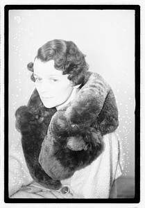 A woman with a fur scarf around her neck