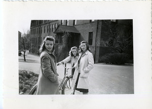 Abbot Academy students walking on campus with bicycle