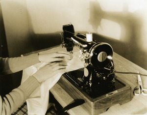 Abbot Academy student running sewing machine in Domestic Science Laboratory