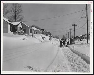 We May regret rejoicing, but so far March, 1957, has been 'way ahead of March, 1956 - weatherwise. At top photo, Hallron street, Hyde Park, looked like this after St. Patrick's Day blizzard. In contrast, fencing students Robin Gal-