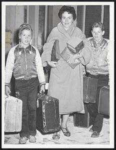 Passengers aboard the New Haven Railroad’s Merchants Limited arrive at South Station about nine hours late. Included are Mrs. Ethel Maunsell of Lynn with her son, Peter, 10, left and George, 12, upper left photo. At lower left are students from Endicott Junior College. They are, back grow, Barbara Schmermond and Susanne Chisholm. In front are Susan Collins and Hope Naylor. Mrs. Frank Kusela holds her daughter, Carol 3, above.