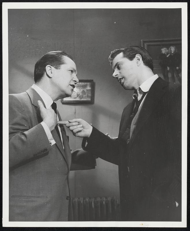 Comedian Joey Adams (left) and singer Johnny Desmond (right) have leading roles in “Play Me Hearts and Flowers,” a new television play about show business by David Shaw, which will be presented on the Philco Television Playhouse on Sunday evening, March 6, at 9 PM EST. Desmond, one of the fastest-rising young singers in the nation, will be playing a dramatic role in “Play Me Hearts and Flowers,” which tells the story of a highly successful comedy team which goes on the rocks after the singing member of the team (Desmond) realizes he is merely a stooge for the knockabout comic (Joey Adams). Ellen Cobb Hill portrays Desmond’s wife, and the cast also includes Kay Medford in a featured role. There are two rather unusual aspects of this particular show. “Play Me Hearts and Flowers” is the title of an actual song which Johnny Desmond has recorded for Coral Records, and which will be issued on Monday, March 7, the day after the television program. Because there is so much song and dance in the play, the Philco Television Playhouse – for the first time in its seven-year history– is telecasting “Play Me Hearts and Flowers” before a live audience. The Century Theatre in New York City has been taken over for the event.