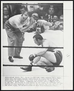 The Long Count--Referee Billy Regan leans over challenger Ingemar Johansson as he counts him out in the sixth round of tonight’s title fight with heavyweight champion Floyd Patterson at Miami Beach. Johansson was floored with a chopping right to the jaw. He started to rise midway in the count, at the count of nine started to rise again but fell back to the canvas. The time was 2:45 of the sixth round.