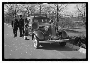 Policemen standing next to Boston Police Safety Education vehicle, Back Bay Fens