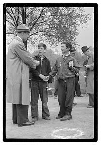 Two boys, both wearing medals, shaking hands