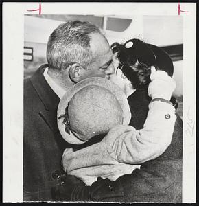 Farewell Kiss- Secretary of State Dean Acheson receives a good-bye kiss from his daughter, Mrs. William Bundy, at airport in Washington before departing for London. Mrs. Bundy holds her son, Michael.