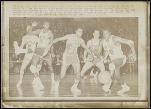 Court Battle Goes to the Floor--Tom Hawkins (33) of the Lakers and Willis Reed (19) of the Knicks are in hot pursuit of rebounding basketball in last night's NBA game at Madison Square Garden in New York. Onlookers are Knick's Dick Van Arsdale (5), left, high-stepping teammate Walt Bellamy (8) and Jerry West of the Lakers. Los Angeles beat New York 122-117.