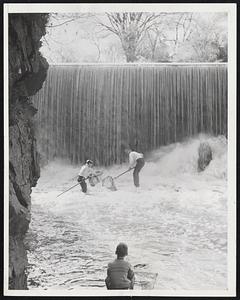 Boys Net Alewives - Boys venture under the 20-foot waterfall in the Stroudwater river at South Portland, Me., to net herring attempting to leap the dam. The annual seasonal urge of the alewives to get upriver provided about two weeks sport with nets for the boys.