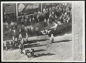 Guards, Pickets Skirmish- National guardsmen clash with three pickets, one of whom attempted to wrest a rifle from a soldier as workers drove into the strikebound Swift & Company packing plant here today. A guardsman, his helmet knocked off, goes down on one knee (low center) as one civilian sprints away, while (left) a know of guardsmen with fixed bayonets overpower a civilian.