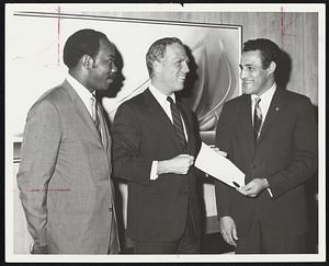 Proclamation naming today "Opportunities Industrialization Center Day" in Boston is handed to OIC Director Gary Robinson, right, by Mayor White. At left is mayoral assistant Herman Hemingway.