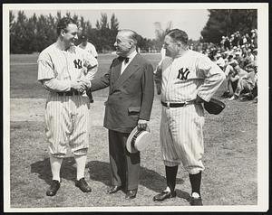Welcome Gehrig to Yankee Camp--Owner Colonel Jacob Ruppert and manager Joe McCarthy (right) welcome "two gun" Lou Gehrig (left) at his first work-out at the Yankee training camp here. The veteran first baseman, whose hold-out ended with the signing of a $39,000 contract last week-end, proved to be a bit rusty in his ball playing after the long Winter lay-off during which he has been playing cowboy parts in the movies.