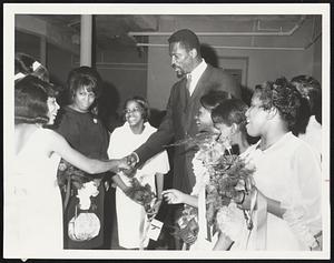 Celtics Player-Coach Bill Rusell shakes the hand of a graduate of the Patrick T. Campbell Junior High School. He addressed the class.