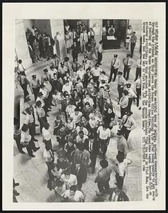 Under the watchful eyes of police, anti-war demonstrators walk through the rotunda as they leave the House Office Building 8/16 after being unable to get seats at hearing of the House Un-American Activities Committee. The committee began hearing 8/16 on anti-war activities. As they marched out, the people chanted: "End the war in Vietnam. Get the troops home. End the War in Vietnam. Get the troops home.: