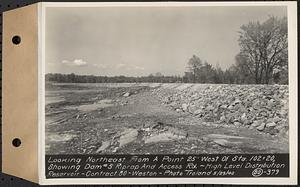 Contract No. 80, High Level Distribution Reservoir, Weston, looking northeast from a point 25 feet west of Sta. 102+20, showing dam 5 riprap and Access Road, high level distribution reservoir, Weston, Mass., May 29, 1940