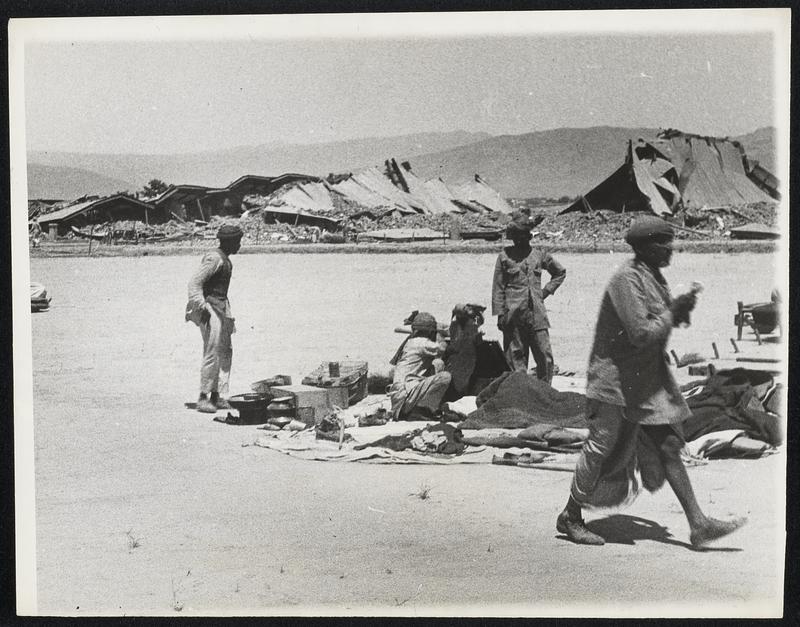 After 'Quake Rocked Quett Twenty-six thousand persons were reported dead in the earthquake which ruined the city of Quetta, India, and wrecked surrounding territory. In this, one of the first pictures to come out of the devastated area. Inhabitants of the city are seen in their impromptu shelter.