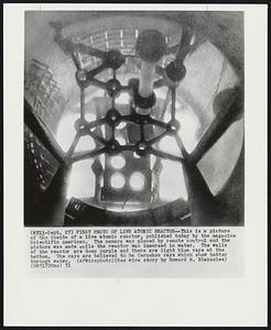 First Photo of Live Atomic Reactor -- This is a picture of the inside of a live atomic reactor, published today by the magazine Scientific American. The camera was placed by remote control and the picture was made while the reactor was immersed in water. The walls of the reactor are deep purple and there are light blue rays at the bottom. The rays are believed to be Cerenkov rays which show better through water.