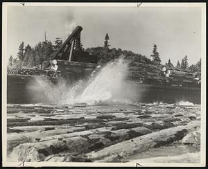 White Water means traveling to a veteran logger. Even as the thumb of a boy nudges a marble, the steam rig shoots a carload of logs at a time into the rafting ponds.