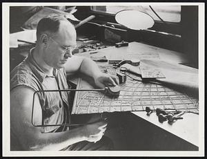 A foundryman is shown in the circle sawing out a section of an original plate preliminary to such an insertion.