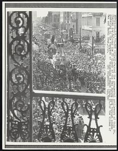 Beyond the ornamental grillework of the St. Charles Ave. Balcony the 22 floats of the Rex Parade move through crowds numbering in the hundreds of thousands toward Canal St. for the climax of Rex and Mardi Gras, 2/10.