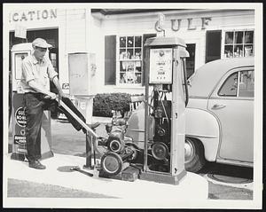 Yep, She Pumps--Cleverest Yankee trick of the hurricane was probably this one by Lloyd Hatch, service station station operator in Greenbush, Scituate. When power failed he rigged his gasoline lawn mower to his gas pump.