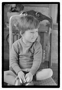 Toddler sitting on a chair