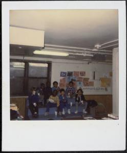 Group of children having a snack on the blue steps