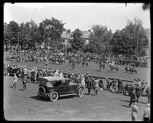 Spectators watching horses and riders