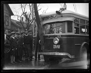 People gathered around a wrecked Melrose bus which has hit a pole