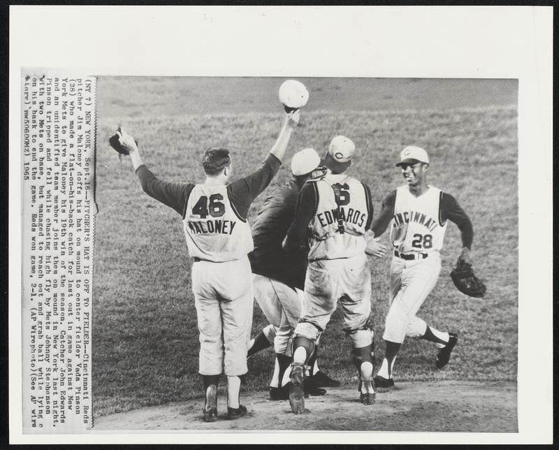 Pitcher's Hat is Off to Fielder -- Cincinnati Reds pitcher Jim Maloney doffs his hat on mound to center fielder Vada Pinson (28) who made a flat-on-his-back catch for last out in game against New York Mets to give Maloney his 19th win of the season. Catcher John Edwards and an unidentified team member joins them on mound in New York last night. Pinson tripped and fell while chasing high fly by Mets Johnny Stephenson with two Mets on base, but managed to reach out and grab ball while lying o on his bask to end the game. Reds won game, 2-1.