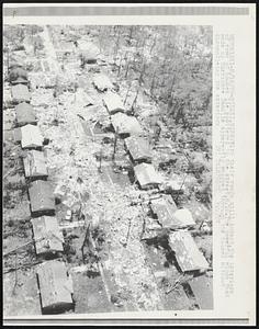 Biloxi, Miss: With their roofs still intact, the interiors of rows of houses lie scattered in the street, 8/18. The powerful winds that made up Hurricane Camille apparently whipped through the houses without dismantling the exteriors.