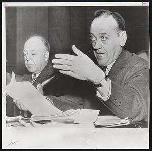 Hand-Waving Gesture is made from stand today by John G. Adams, the Army's former chief counsel, as he denies a charge by Sen. Joseph McCarthy (R-Wis). Adams was a witness in Washington before the Senate Investigation of the Maj. Irving Peress case. At left is Wilber Brucker, Defense Department counsel.